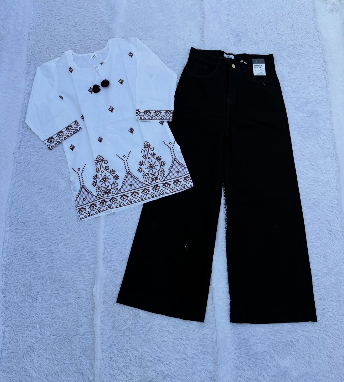 “Elegant Contrast: White Embroidered Top Meets Black Wide-Leg Palazzo Pants”