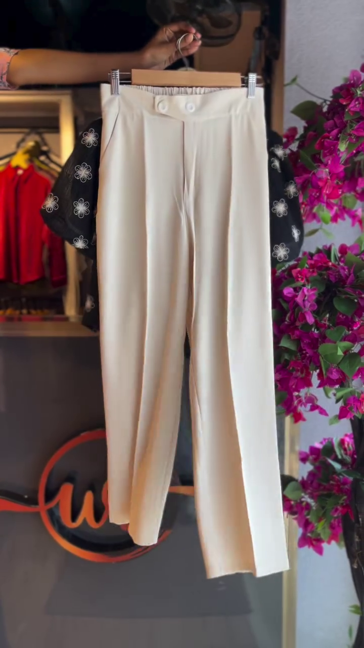 “Chic & Contemporary: Black Embroidered Floral Shirt with White Top and Cream Trousers”