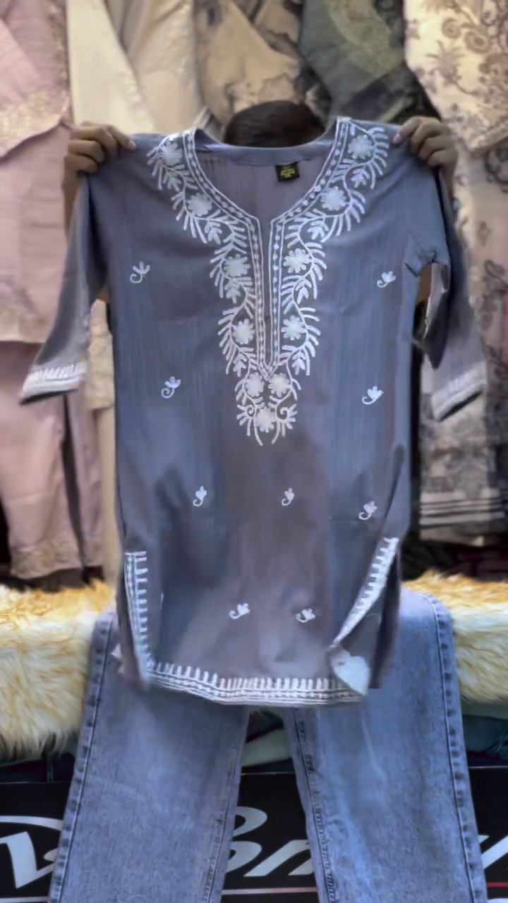 Stylish Denim Blue Embroidered Kurti with White Floral Neckline, Delicate Motif Detailing, Three-Quarter Sleeves & Decorative Hem for Casual Everyday Ethnic Wear
