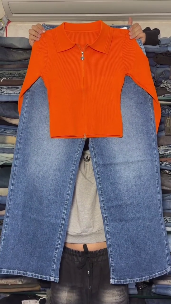 Trendy Orange Ribbed Zip-Up Collared Top Paired with Classic Light Blue Wide-Leg Denim Jeans for a Stylish Casual Outfit