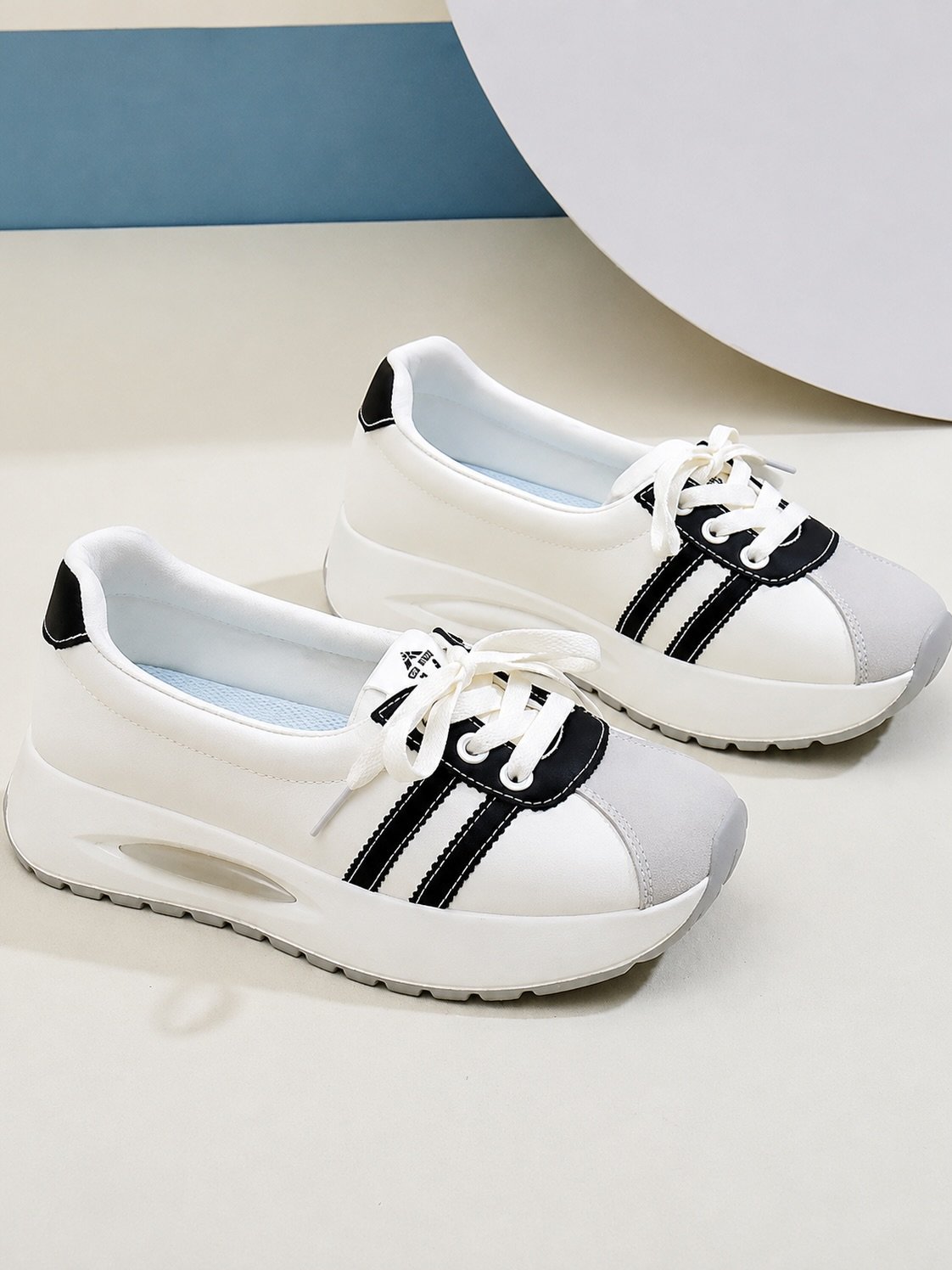 Stylish White Sneakers with Black Striped Design